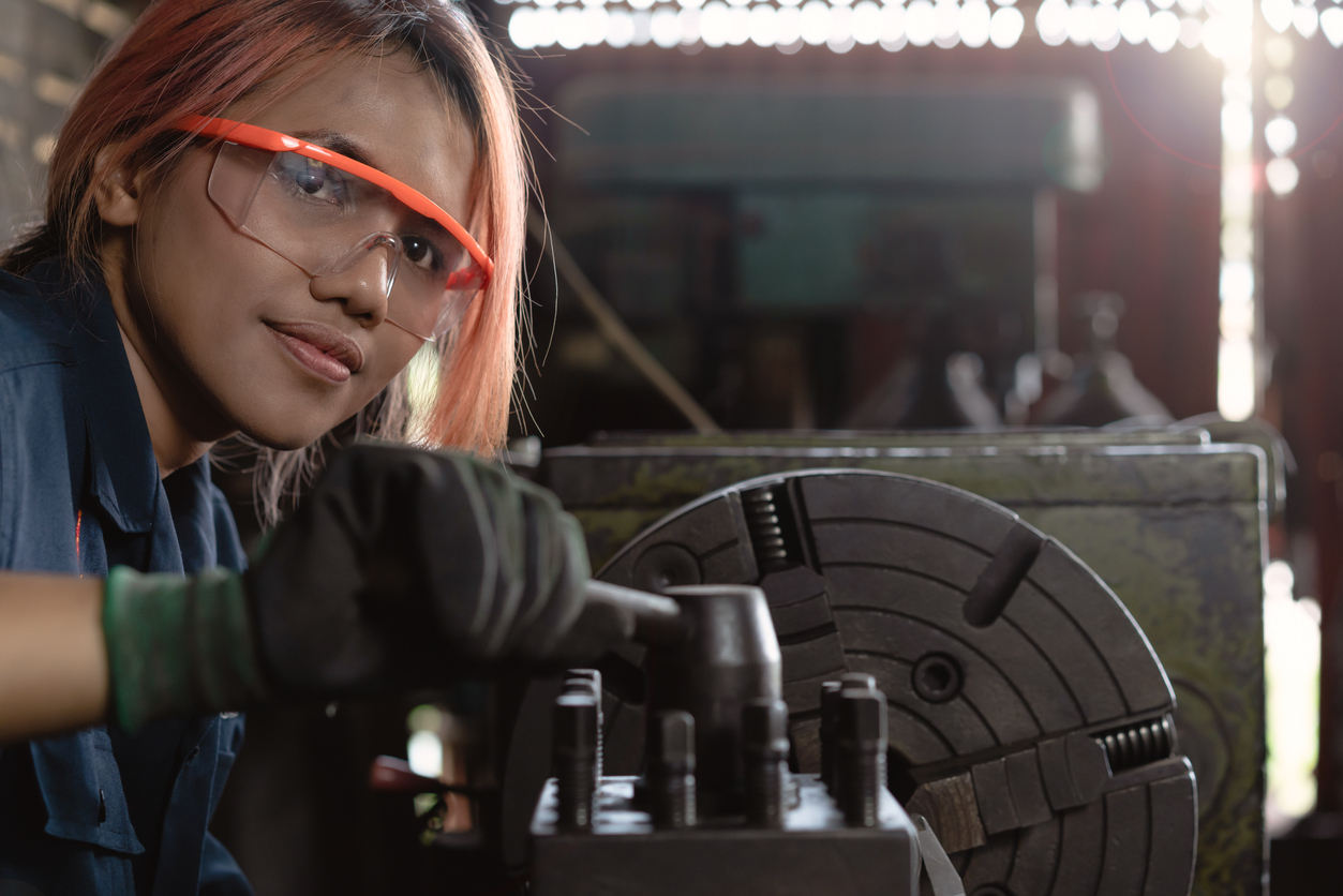 Certified industry female mechanical engineer working on industrial